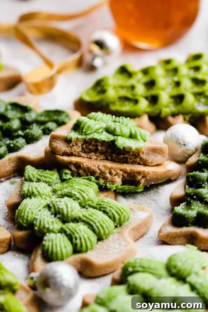 Honey Cream Dream Cookies 3 Honey cookies decorated like christmas trees in various shapes and colors, on a sugary backdrop.