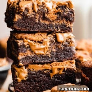 Decadent Biscoff Brownie Bombs 11 A stack of biscoff brownies with visible cookie butter swirls and fudgy texture.