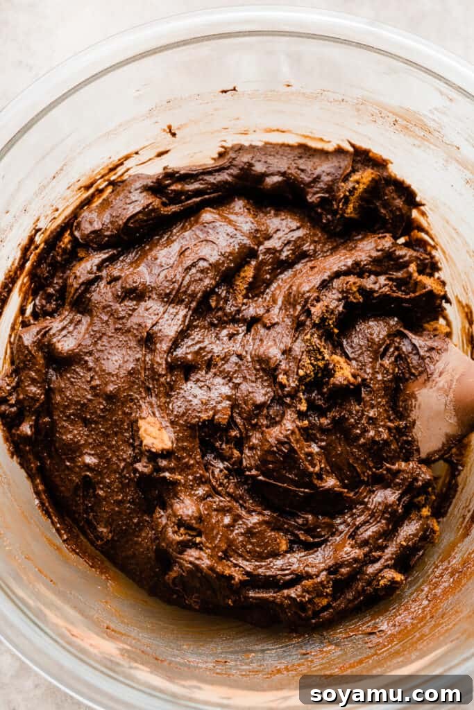 Decadent Biscoff Brownie Bombs 5 A bowl of rich, fudgy brownie batter with Biscoff cookie pieces mixed in, ready for baking.