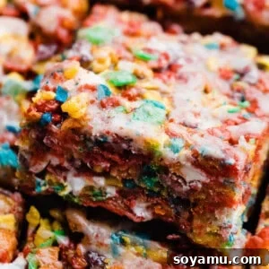 A close-up of a brown butter Fruity Pebbles treat with cereal glaze, highlighting its colorful and textured surface.
