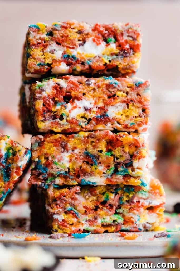 A neat stack of colorful brown butter Fruity Pebbles treats, showcasing their vibrant appearance and appealing texture.