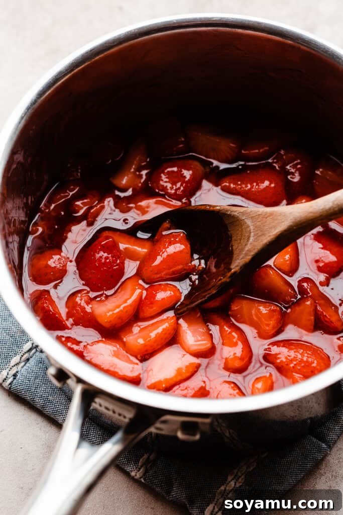 Easy 10-Minute Strawberry Compote 5 A pot of cooked strawberry compote, showcasing its rich, thickened texture and vibrant red color, ready to be cooled.