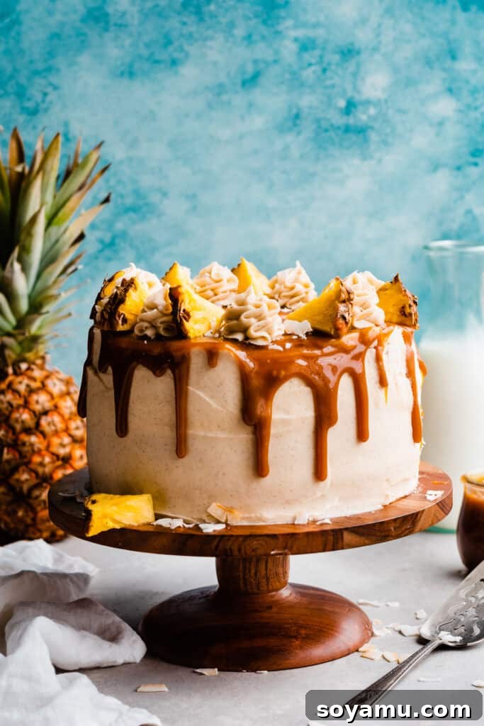 Piña Colada Dream Cake 11 The full decorated cake with a blue backdrop.