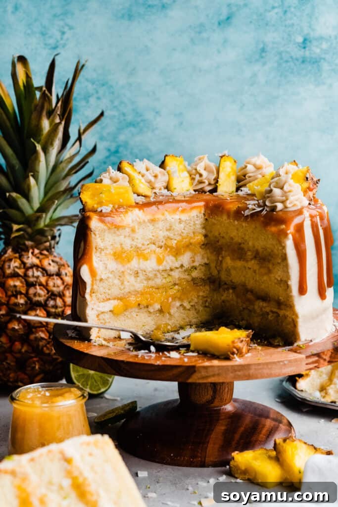 Piña Colada Dream Cake 12 The sliced pina colada cake, with layers of cake, frosting, and pineapple filling visible.