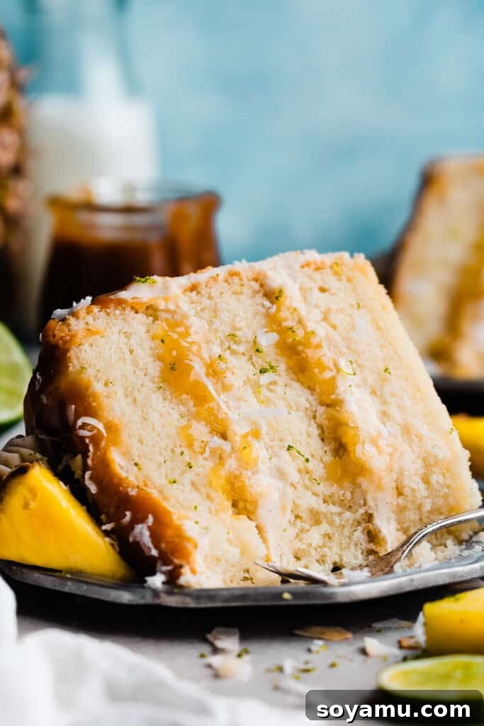 Piña Colada Dream Cake 13 A slice of pina colada cake on a plate, with a few bites missing.