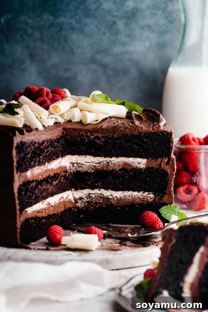 The impressive sliced Tuxedo Cake presented on a elegant marble slab, showcasing its decadent layers.