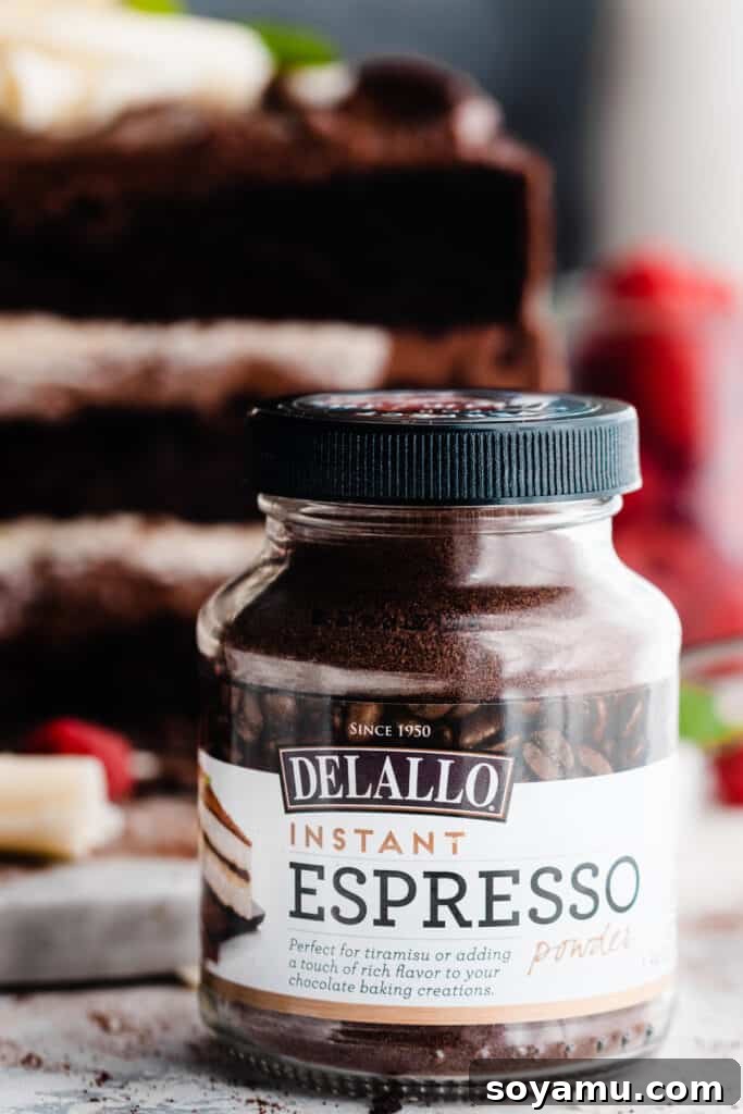 A close-up photograph of a jar of DeLallo Instant Espresso Powder, highlighting its importance in enhancing chocolate flavor.
