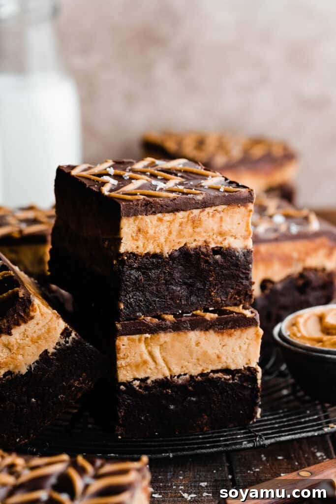 Buckeye Bliss Brownies 3 A perfectly arranged stack of three-layer Buckeye brownies, highlighting their distinct chocolate and peanut butter layers.