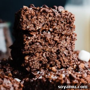 A stack of chocolate rice krispie treats, enhanced with brown butter and flaky sea salt.