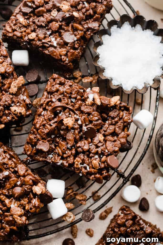 A close-up of a stack of golden brown butter chocolate crispy treats on a vintage rack.