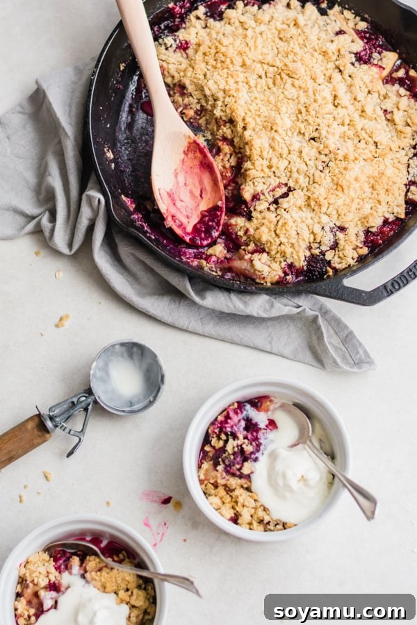 A beautifully baked Summer Glory Skillet Crumble, golden and bubbling, served warm in a cast iron skillet.