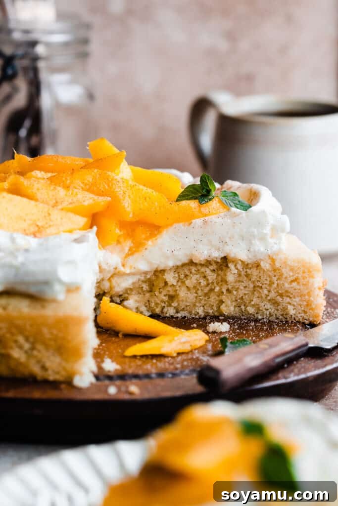 Tropical Mango Snack Delight 3 The sliced mango cake on a wooden cake plate, revealing its beautiful layers.