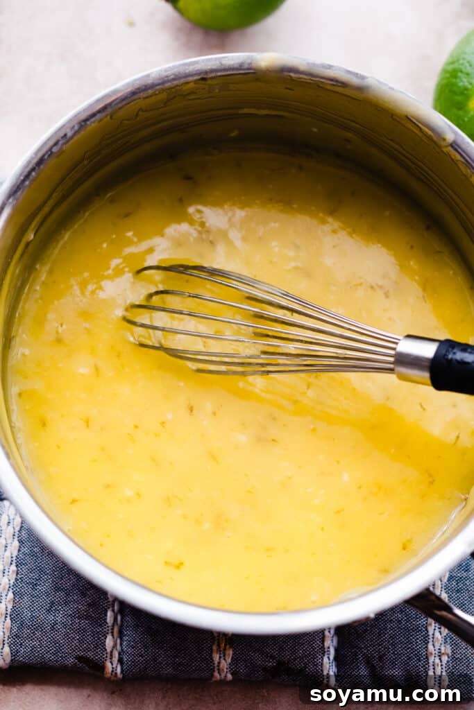 Zesty Homemade Lime Curd 6 A whisk in a pot of the curd ingredients.