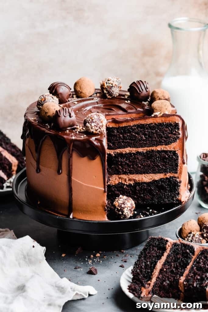 Velvet Chocolate Truffle Cake with Creamy Milk Chocolate Frosting 2 The sliced open chocolate truffle cake topped with chocolate drip and chocolate truffles.