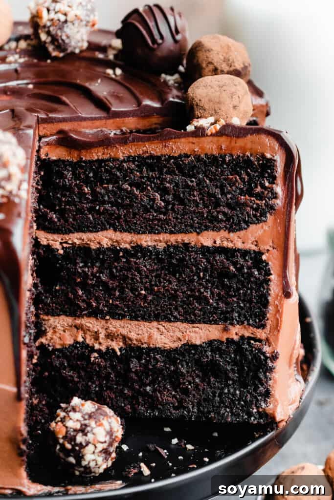 Velvet Chocolate Truffle Cake with Creamy Milk Chocolate Frosting 4 A close-up of a slice of chocolate truffle cake on the cake stand.