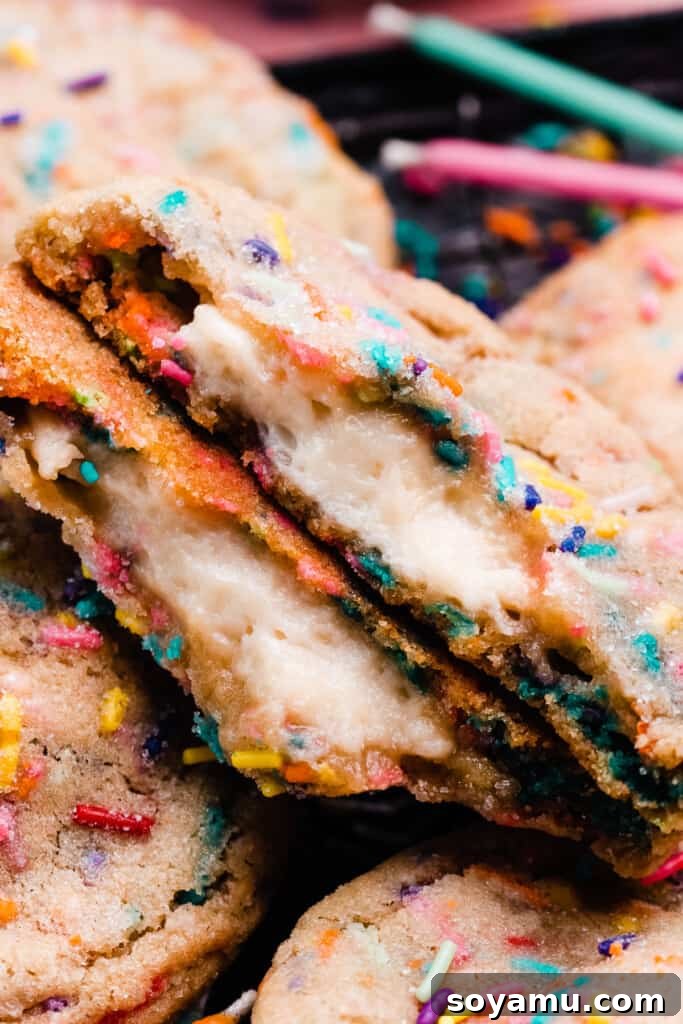 Irresistible Funfetti Cookies with a Cake Batter Cheesecake Surprise 10 A close-up on a broken open funfetti cookie, revealing the creamy cake batter cheesecake filling inside its soft, sprinkle-filled center. The textures are inviting and delicious.