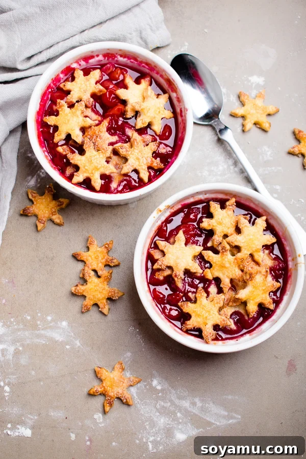 Warm cherry cobbler for two with a golden, flaky crust, ready to be served.