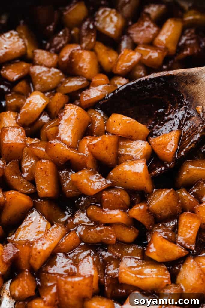Autumn Apple Caramel Delight 5 A close-up view of the perfectly cooked spiced apple filling in a pan, with tender, caramelized apple pieces.