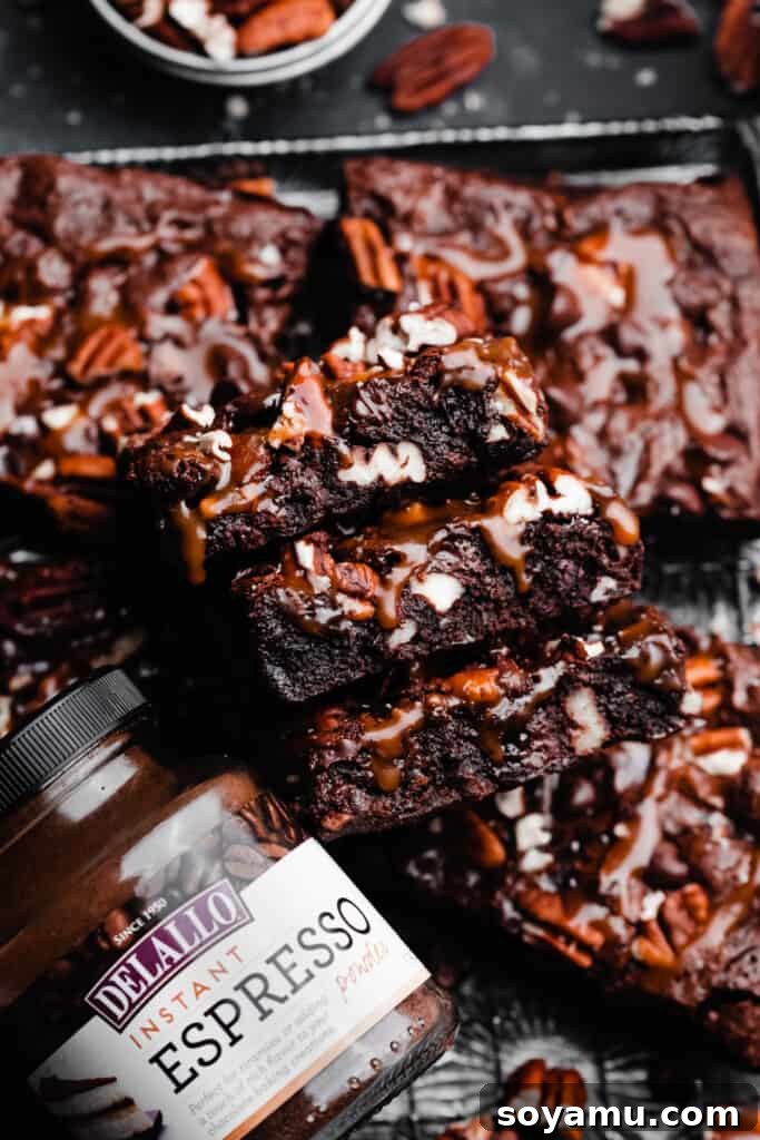 Irresistible Turtle Brownies 9 A stack of turtle brownies with a jar of espresso powder nearby.