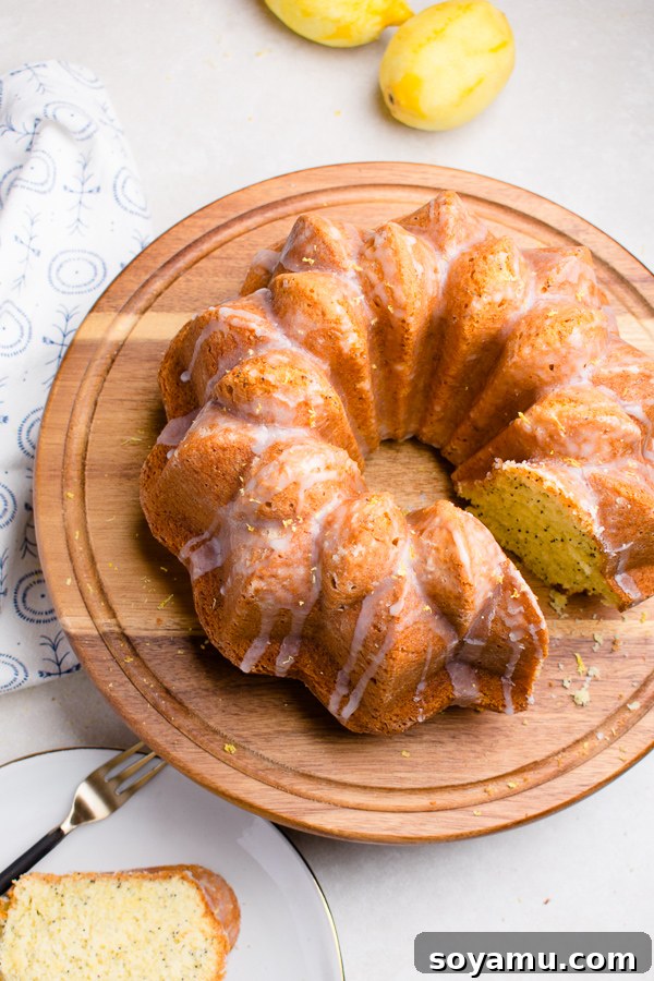 Close-up of a slice of Lemon Poppy Seed Bundt Cake showing its fluffy texture and poppy seeds
