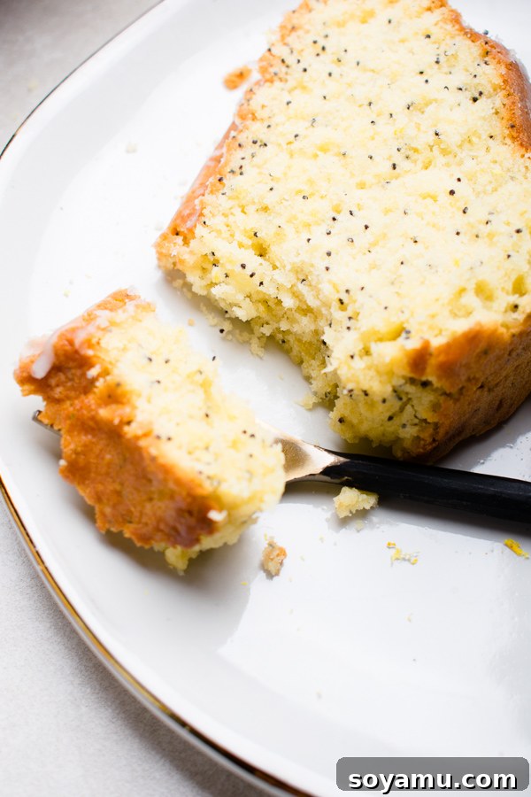 Two slices of Lemon Poppy Seed Bundt Cake served on a plate