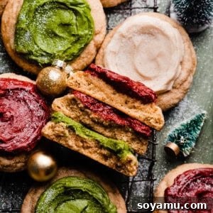A stack of cookie halves surrounded by frosted sour cream cookies on a vintage wire rack.