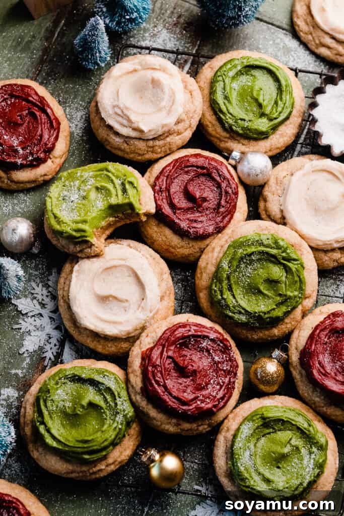 Ultra Chewy Frosted Sour Cream Cookies 4 Frosted sour cream cookies on a wire rack, decorated in festive red, white, and green colors, showcasing their inviting appeal.