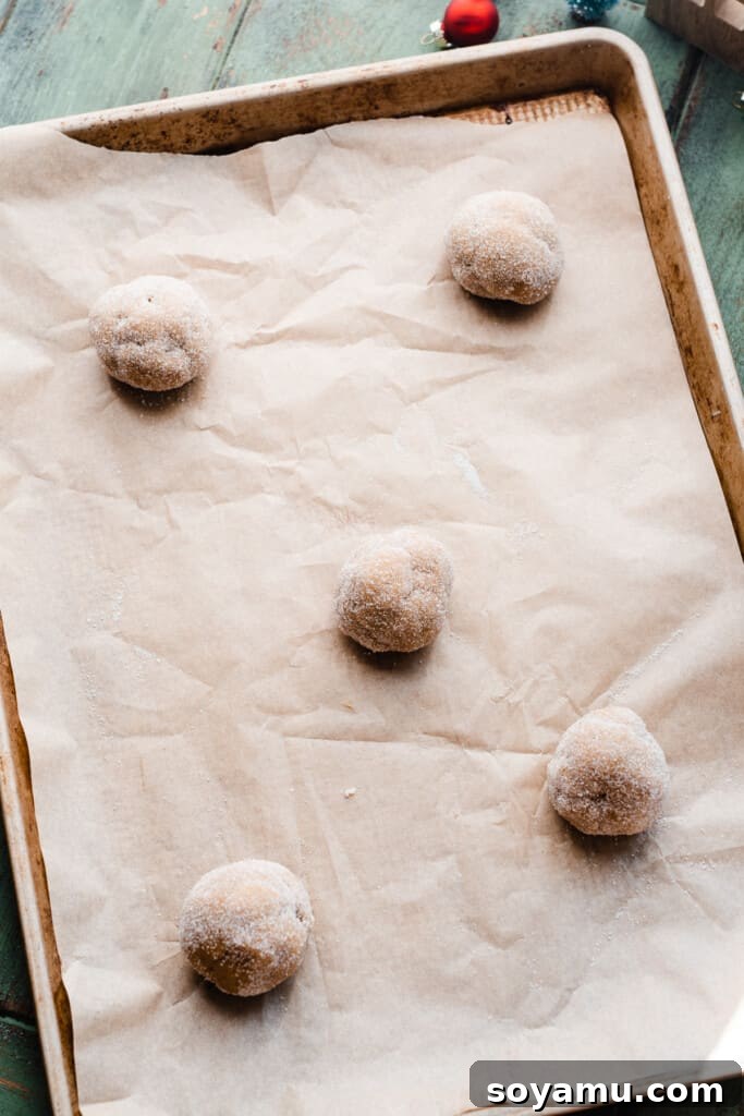Ultra Chewy Frosted Sour Cream Cookies 7 A pan of chilled cookie dough balls, perfectly rolled in granulated sugar, ready for baking.