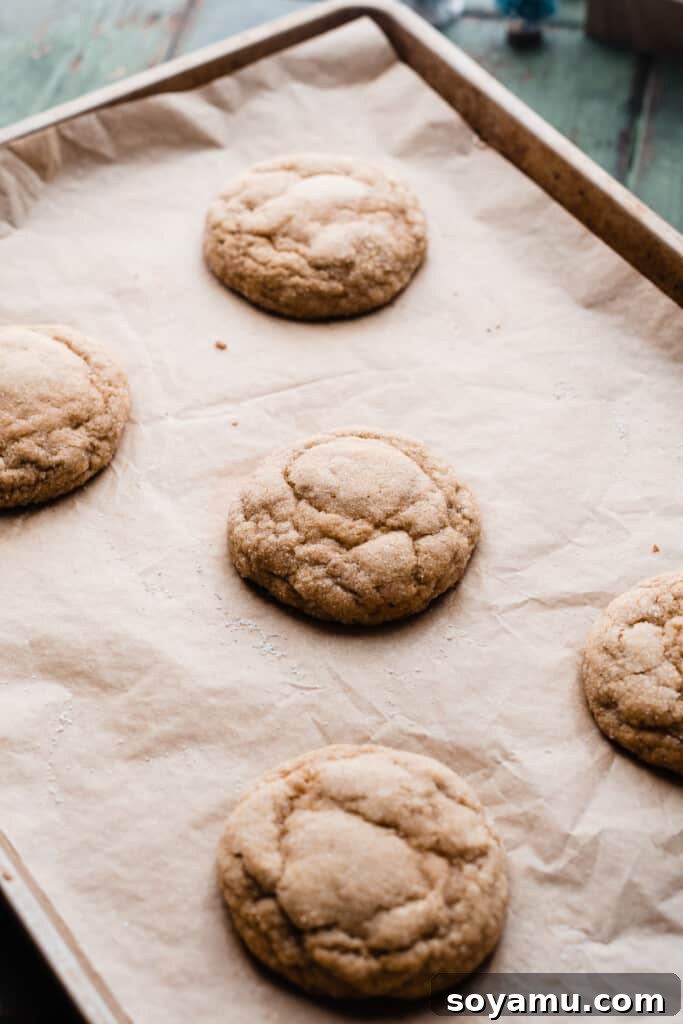 Ultra Chewy Frosted Sour Cream Cookies 8 A pan of perfectly baked sour cream cookies, puffed and crinkly, cooling on a wire rack, ready for frosting.