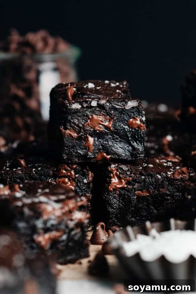 Ultra Fudgy Gluten Free Brownies 8 A stack of perfectly fudgy gluten-free brownies, showcasing their irresistible texture and deep chocolate color.