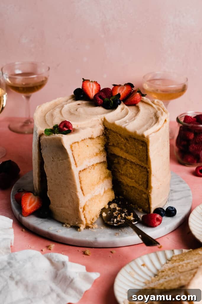 Decadent 8-inch Vanilla Cake with Golden Brown Butter Frosting 9 The sliced 8-inch vanilla cake with a cut slice leaning against the cake.