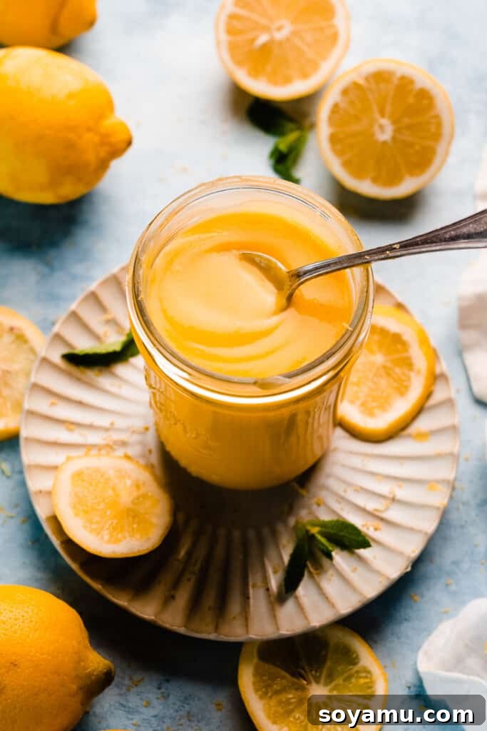 A charming glass jar filled with bright, homemade lemon curd, ready for use.
