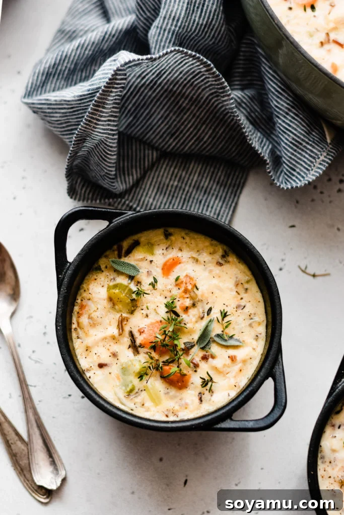 Soulful Chicken Wild Rice Soup 9 A small, inviting bowl of the creamy chicken wild rice soup, garnished with fresh herbs, ready to be savored.