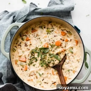 Soulful Chicken Wild Rice Soup 10 A large Dutch oven brimming with the creamy chicken wild rice soup, garnished with fresh parsley.