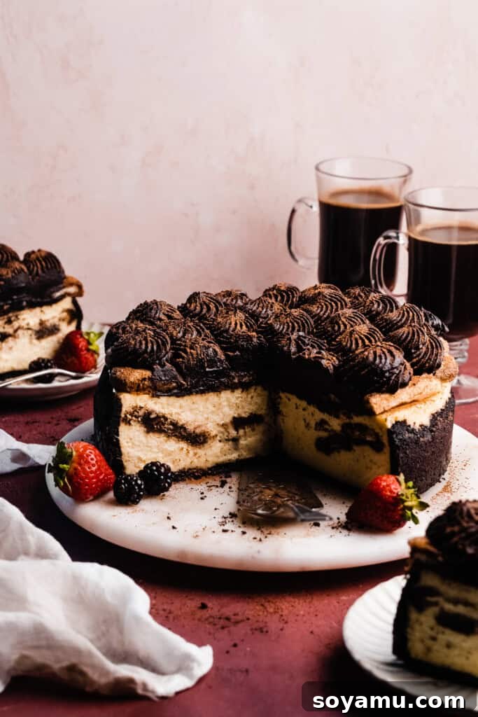 Decadent Mocha Tiramisu Cheesecake 2 A perfectly sliced Tiramisu Cheesecake on a marble plate, showcasing its distinct layers of crust, espresso-soaked ladyfingers, and creamy filling topped with chocolate espresso cream.