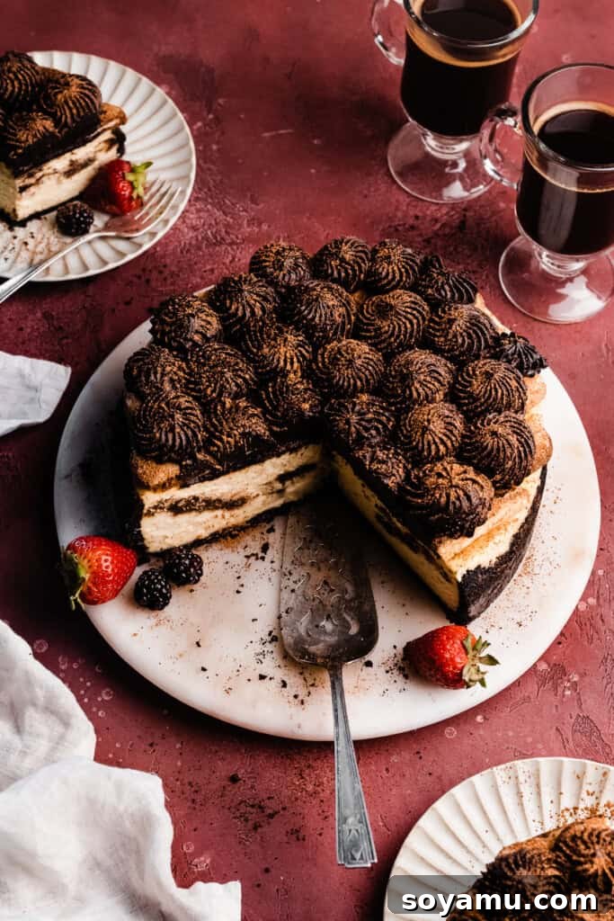 Decadent Mocha Tiramisu Cheesecake 11 A three-quarter view of the perfectly sliced tiramisu cheesecake on an elegant marble cake plate, revealing its detailed layers.
