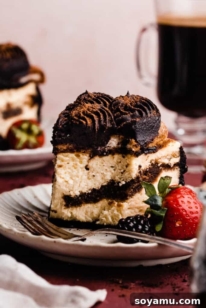 Decadent Mocha Tiramisu Cheesecake 12 A detailed close-up of a slice of the Tiramisu Cheesecake on a plate, with a bite taken, highlighting its creamy interior and distinct layers.