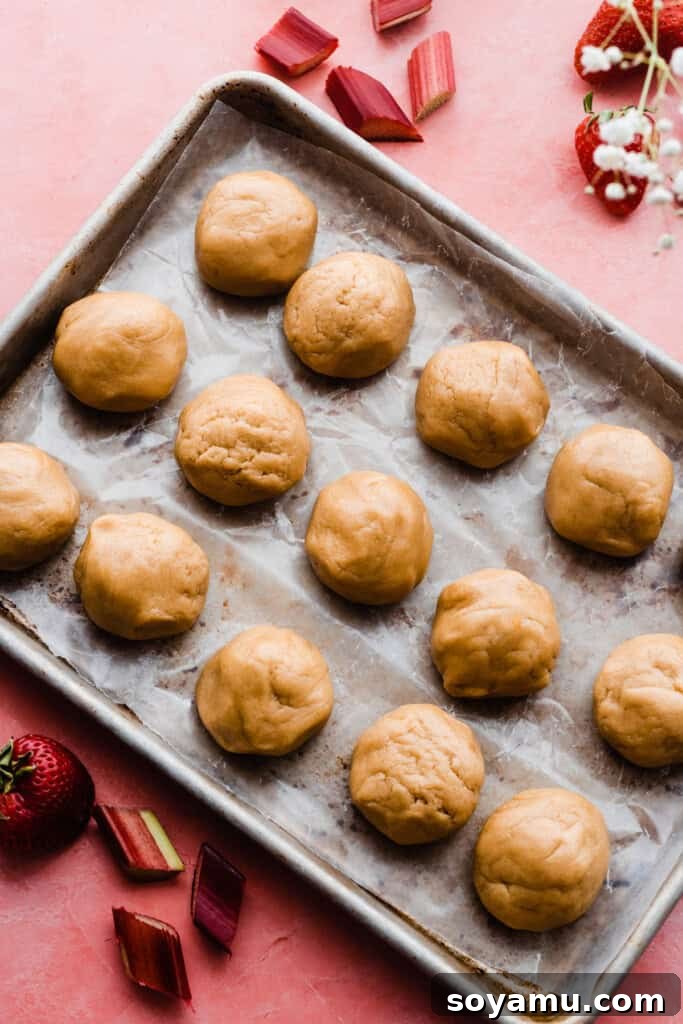 A tray filled with neatly scooped cookie dough balls, perfectly chilled and ready for baking.