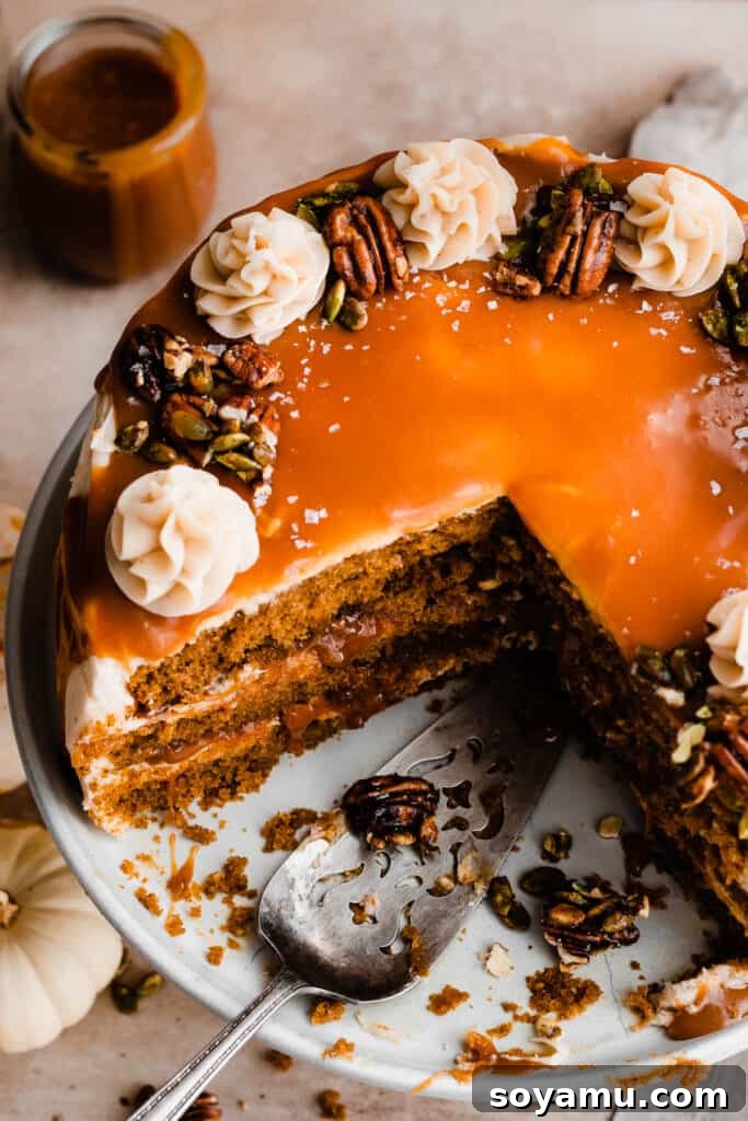 Decadent 10-Minute Salted Caramel Sauce 3 Rich salted caramel sauce cascading over a luscious pumpkin layer cake, highlighting its pourable consistency.