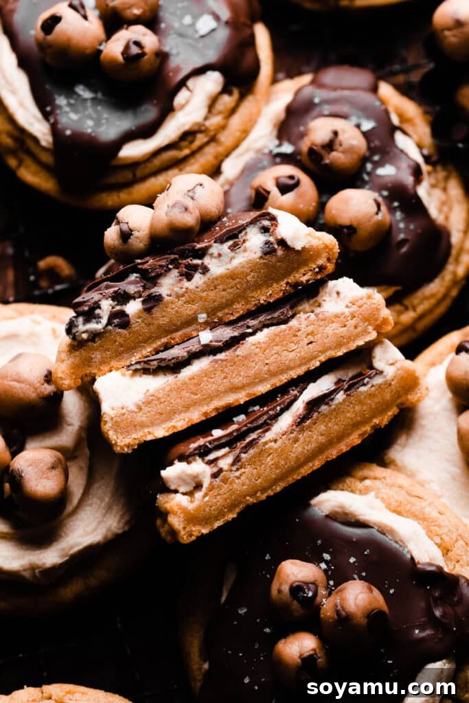 A stack of three cookie halves, revealing the thick and soft interior of the freshly baked cookie dough cookies.