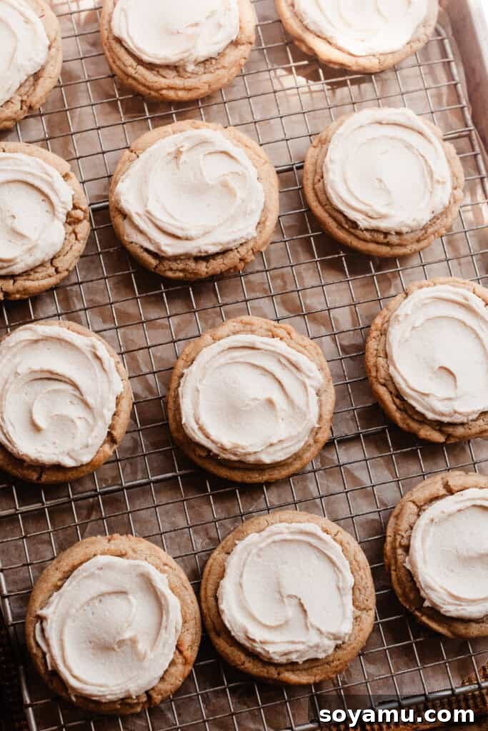 A pan filled with beautifully frosted cookie dough cookies, awaiting their final decorations.