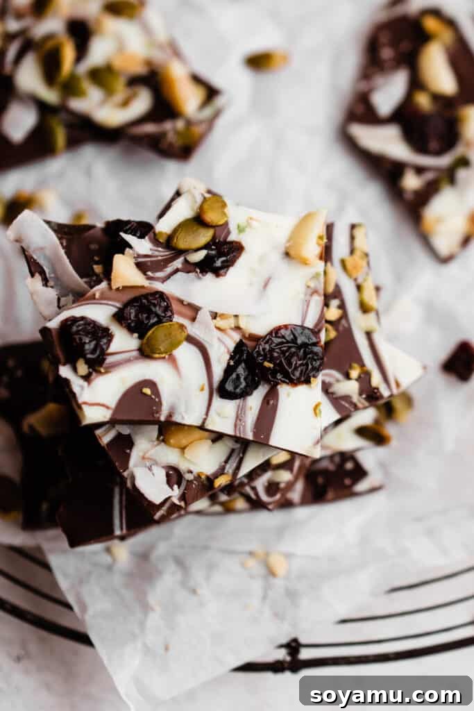Easy Five-Ingredient Homemade Chocolate Bark 7 A top-down view of a delightful stack of homemade chocolate bark, showcasing its intricate layers and colorful toppings.