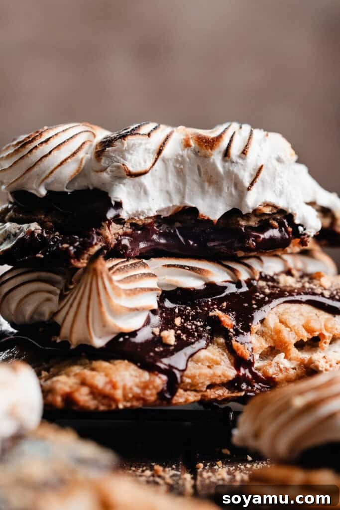 A s'mores pop tart with a bite missing, stacked on top of another one, showcasing its delicious layers.