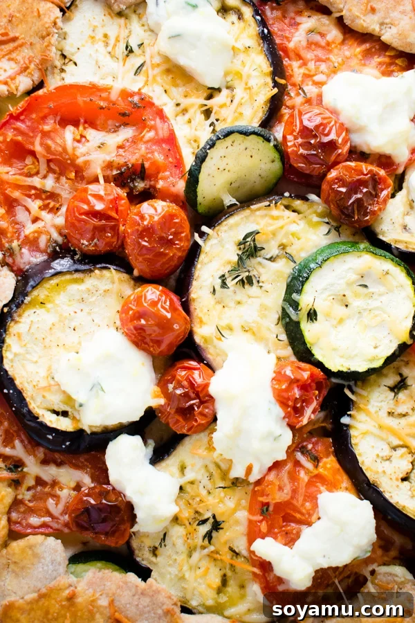 A close-up shot of the Mixed Vegetable Galette, highlighting the rich cheese and baked vegetables.
