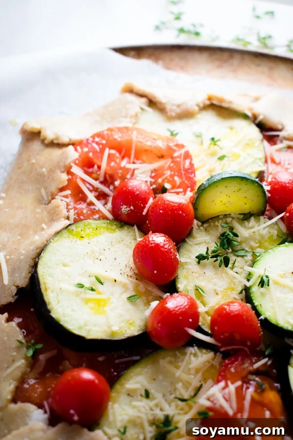 Overhead shot of the Mixed Vegetable Galette with a serving knife, ready for slicing.