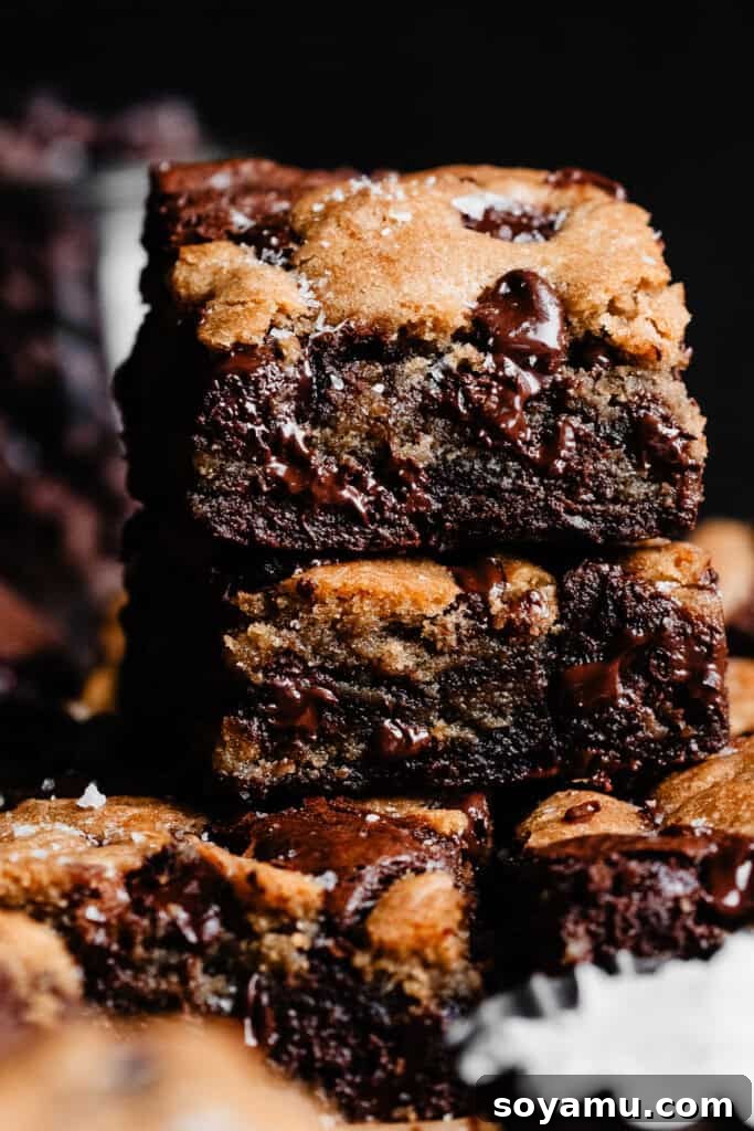 Nutty Brown Butter Brookies 3 A close-up stack of several brookies, highlighting their gooey, fudgy brownie centers and soft, chewy cookie tops.