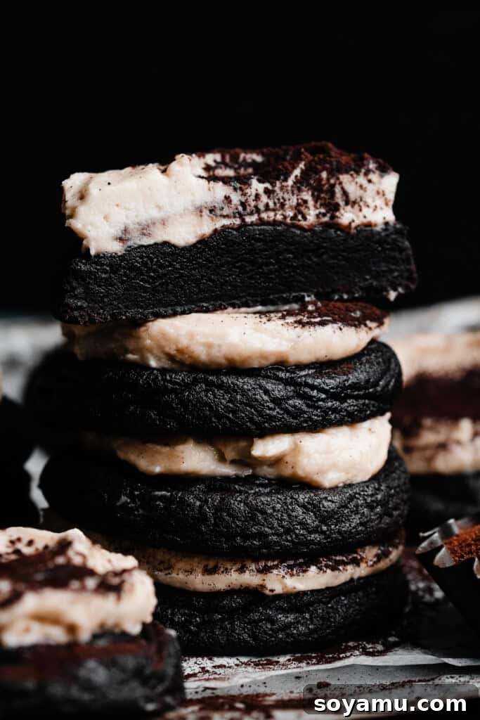 Tiramisu Cloud-Topped Cookies 2 A stack of rich chocolate Tiramisu Cookies topped with Whipped Mascarpone Frosting and cocoa powder.