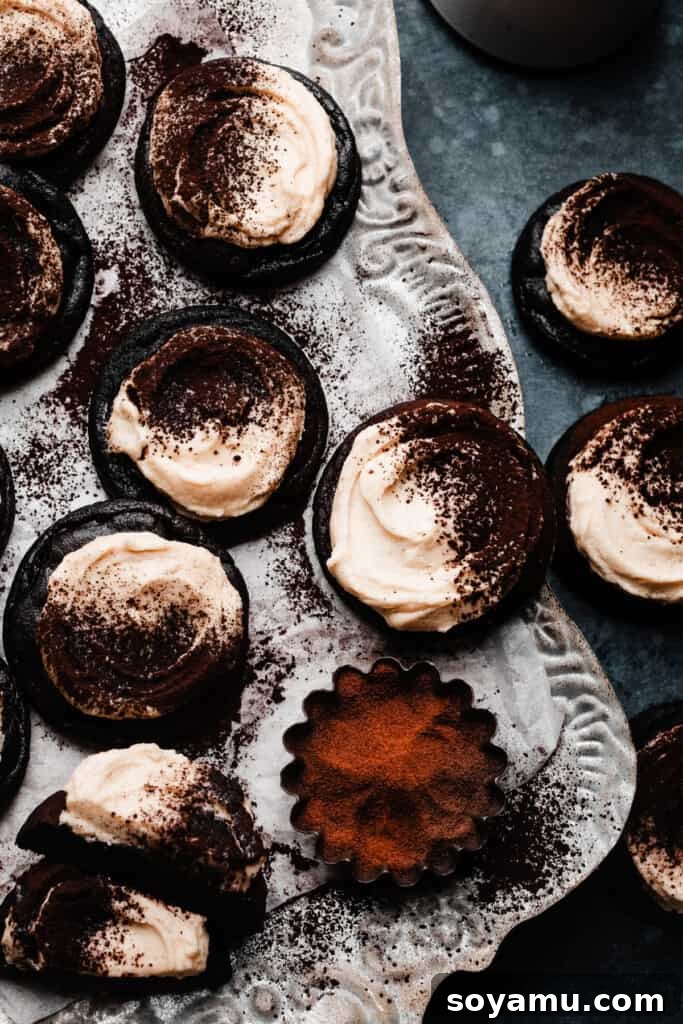 Tiramisu Cloud-Topped Cookies 11 Cocoa dusted tiramisu cookies artfully arranged on a rustic vintage tray, inviting indulgence.