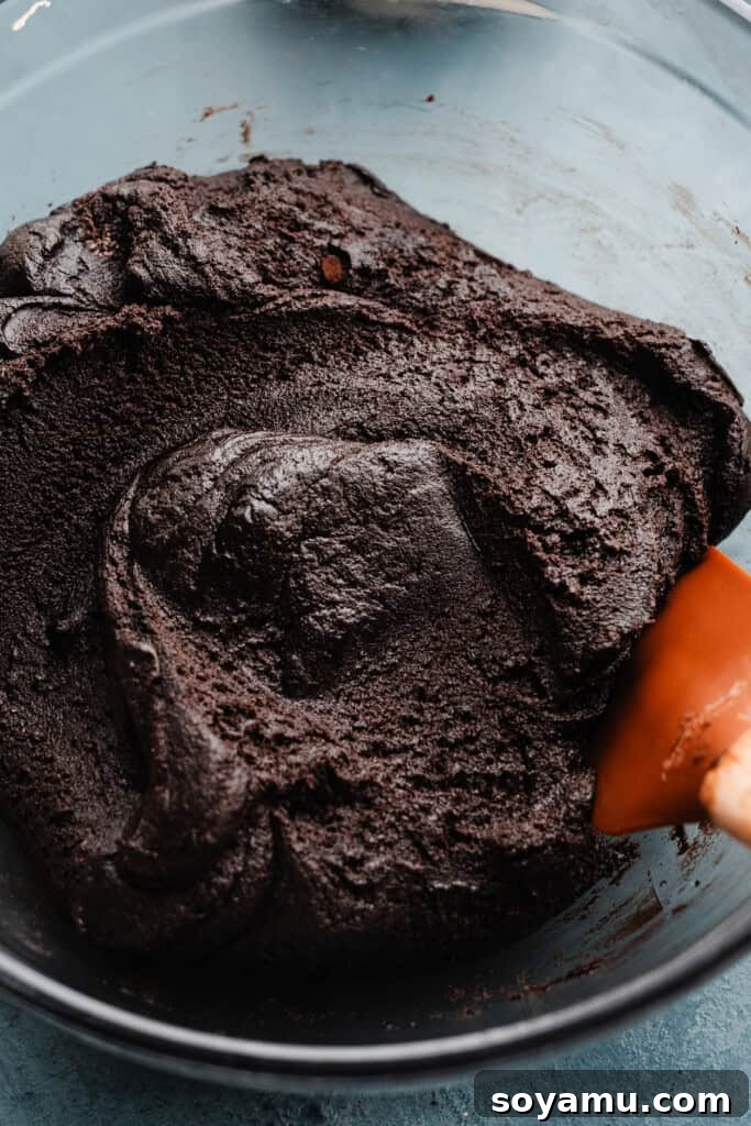 Tiramisu Cloud-Topped Cookies 4 A bowl of rich chocolate espresso cookie dough, showcasing its dark, smooth texture.