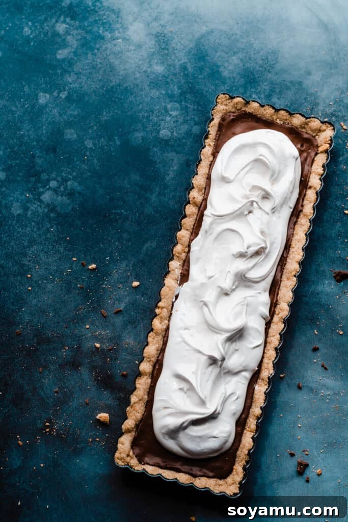 Gourmet S'mores Tart with Torched Meringue 9 The fully assembled S'mores Tart, with its baked crust, melted chocolate, and fluffy marshmallow meringue topping, beautifully toasted.